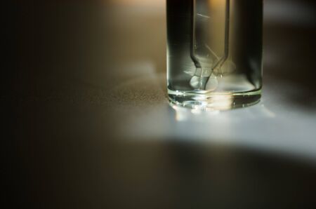 Cosmetic or medical glass bottle with pipette. Skin care concept. Natural hard light, deep shadows....