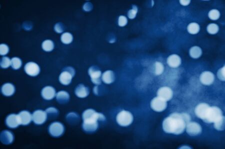 Defocused blue sparkles on black background. Color of the year 2020 Classic Blue. - Imageの写真素材