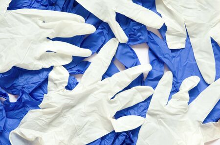 White and blue surgical gloves isolated on white background.の写真素材