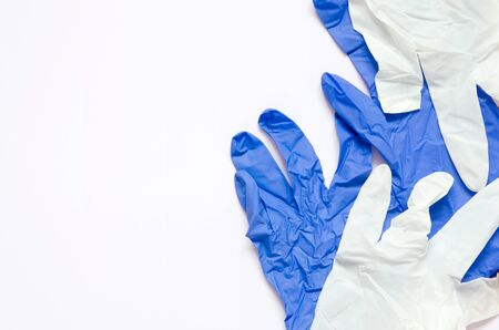 White and blue surgical gloves isolated on white background.の写真素材