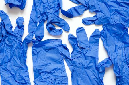 White and blue surgical gloves isolated on white background.の写真素材