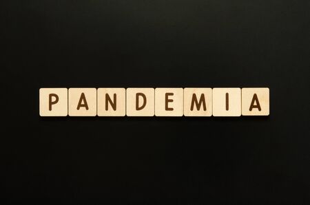 PANDEMIA - word from wooden blocks with letters. Top view on black background. - Imageの写真素材