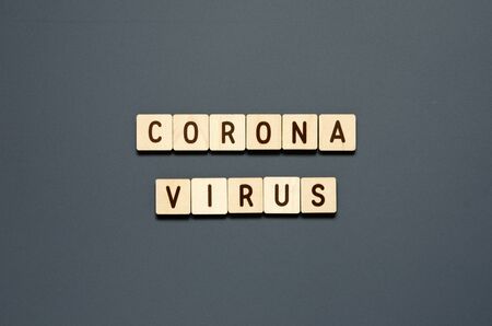 CORONAVIRUS - word from wooden blocks with letters. Top view on gray background. - Imageの写真素材