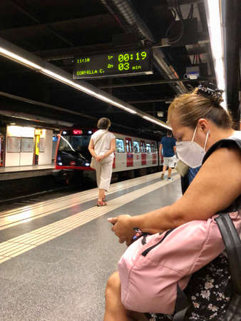 Barcelona, Spain, July 15, 2020: Passengers in protective masks standing in the metro of Barcelonaのeditorial素材