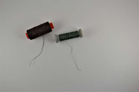 Colored thread coils on white desk. Place for textの写真素材
