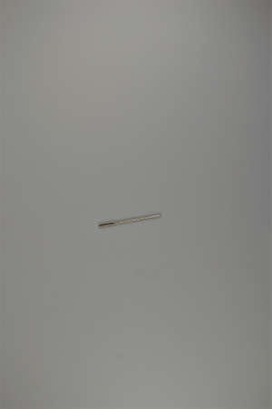Sewing needle on white desk surface. Place for textの写真素材
