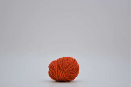 Colorful red ball of wool isolated on a white background