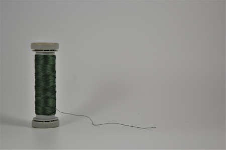 Colored thread coils on white desk. Place for textの写真素材