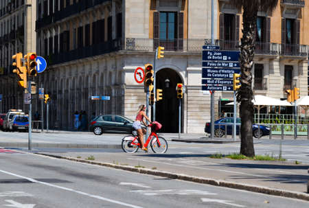 Barcelona, Spain, August 8, 2020: Woman in a bike wearing protective medical masks for prevent virus Covid-19 in Barcelona, Spain, Europeのeditorial素材