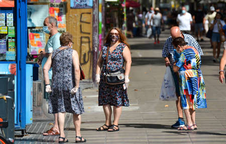 Barcelona, Spain, August 9, 2020: Spanish people walking around wearing protective medical masks to prevent virus Covid-19 in Barcelona, Spain, Europe. Tourist spots in the covid eraのeditorial素材