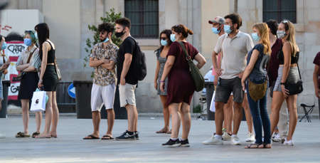 Barcelona, Spain, August 24, 2020: Caucasian group of people wearing protective covid-19 face mask....