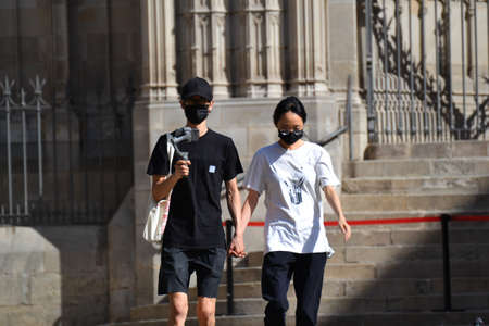 Barcelona, Spain, August 24, 2020: Asian couple wearing protective covid-19 face mask. Touristy...