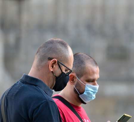 Barcelona, Spain, August 24, 2020: Caucasian men wearing protective covid-19 face mask. Touristy spots in the covid eraのeditorial素材
