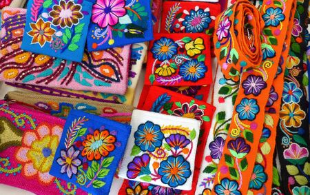 Handicraft souvenirs from Peru with flowers embroidery at the international fair on Independence day of Cuencaの写真素材