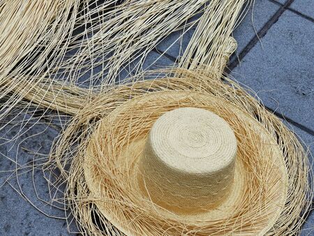Ecuadorian handmade toquilla straw hat ( hat), not finished,  on concrete background. Popular souvenir from South America, Cuencaの写真素材