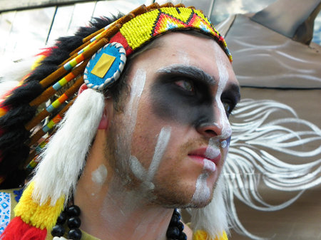Cuenca, Ecuador - January 6, 2020: Traditional parade or masquerade on Day of the Innocents. Young man dressed as native american indianのeditorial素材