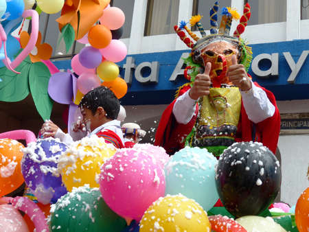 Cuenca, Ecuador - February 22, 2020: Carnival parade in Cuenca city. Man dressed as character of Inti Raymi celebration called Diablo Huma (Devil) greets publicのeditorial素材