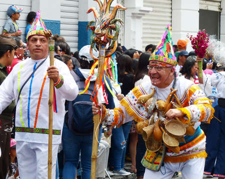 Cuenca, Ecuador - February 22, 2020: Carnival parade in Cuenca city. Folk dancers as participants of parade spraying foam on everyone which is traditional fun in Ecuadorのeditorial素材