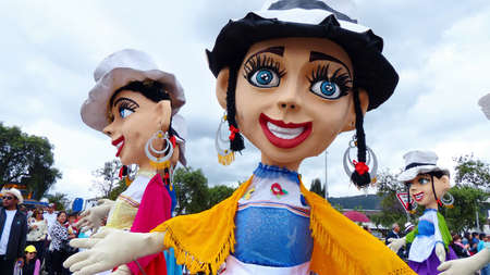 Cuenca, Ecuador - November 1, 2019: Giant mannequins in costumes typical for Azuay province as cholas cuencanas at the traditional parade for day independence of Cuenca, Ecuadorのeditorial素材