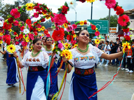 Cuenca, Ecuador - November 1, 2019: Traditional parade on day of  independence of Cuenca. Folk dancers from Otavalo. Dance with flowersのeditorial素材