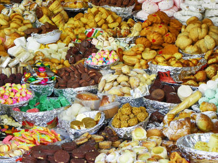 Traditional sweets: cookies, jelly, candy, chocolate, marshmallow, nuts and more  during catholic Corpus Christi celebration in numerous stands at open market in Cuenca, Ecuadorの写真素材