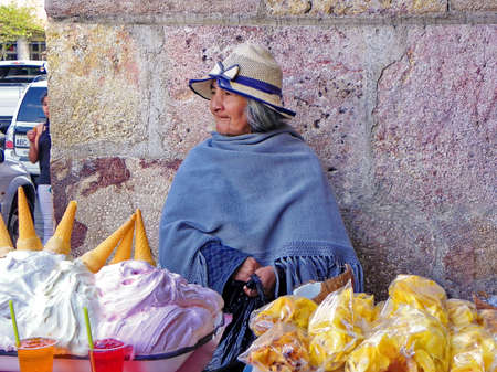 Cuenca, Ecuador - June 7, 2015: Portrait of an unknown indigenous Ecuadorian woman selling traditional for Ecuador dessert called espumilla and bannana's chipsのeditorial素材