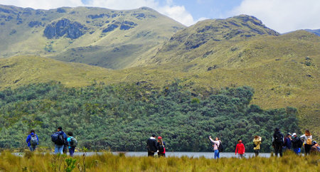 Azuay province, Ecuador - December 12, 2020: Unidentified tourists next to the mountain lake at Cajas National Park, ecuadorian Andesのeditorial素材