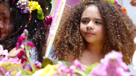 Cuenca, Ecuador-February 22, 2020: Annual carnival parade in Cuenca city. Little cute girl  in parade. Drops of spraying foam are in the air. Tradition way to celebrate carnival in Ecuadorのeditorial素材
