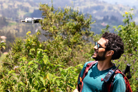 Azogues, Ecuador - February 22, 2022: Tourist plays with drone while mountain hiking. The hill...