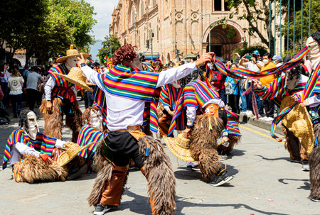 Cuenca, Ecuador - December 24, 2021: The Christmas parade Pase del Nino Viajero (Traveling Child) at historic center of city Cuenca. Dancers in costumes of folk characters. Cuenca,のeditorial素材