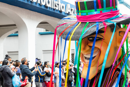 Cuenca, Ecuador - February 26, 2022: Carnival parade in the historic center of city Cuenca. Giant puppet as ecuadorian. Ecuadorのeditorial素材