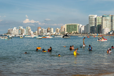 Salinas, Ecuador - March 24, 2023: Crowdy beach in Salinas with view at modern apartment buildings along the beach. Pacific Coast, Ecuadorのeditorial素材