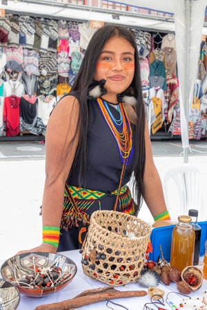 Puyo, Ecuador-March 25,2023: A young beautiful indigenous Shuar woman in typical dress and face...