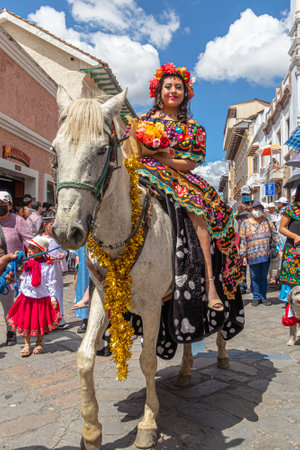 Cuenca, Ecuador - December 24, 2022: Pase del NiÃ±o Viajero (Traveling Child) Christmas procession in Cuenca. UNESCO cultural heritage. Beautiful woman riding a white horseのeditorial素材