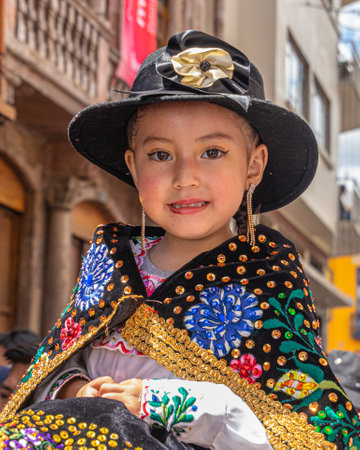 Cuenca,Ecuador-December 24, 2022:Pase del NiÃ±o Viajero (Traveling Child) Christmas Parade in Cuenca. UNESCO cultural heritage. A girl dressed up for the parade in embroidered clothのeditorial素材