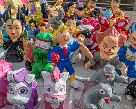 Cuenca, Ecuador -December 29, 2022: Papier-mÃ¢chÃ© dolls or Monigotes depicting different heroes and characters for sale in a street market to be burned out to celebrate New Year's Eveのeditorial素材