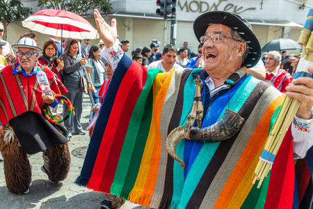 Cuenca, Ecuador - February 18, 2023: Parade during the Carnival in Cuenca. Senior folk dancer among the participants parade. Foam is splashed on everyone, which is a traditional paのeditorial素材