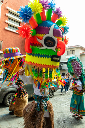Cuenca, Ecuador - February 18, 2023: Big parade during the Carnival in the historic center of the Cuenca. A giant mannequin in the form of a folklore character Diablo Huma (Devil).のeditorial素材