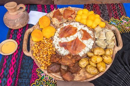 Traditional dishes of Ecuadorian highlands: toasted corn, mote (cooked mature corn), hornado (grilled pork), fritada de chancho (pork fry-up), potato balls, pig's skin, potatoesの写真素材
