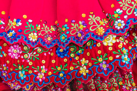 Cuenca, Ecuador - July 15, 2022: Close-up of the embroidered bottom edge of skirts, traditional...