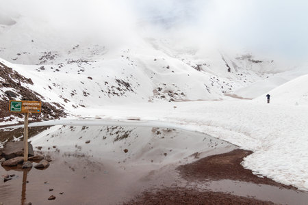 Snowy and sunny Chimborazo volcano in Ecuadorian Andes. The lake and the sign of the lake name...