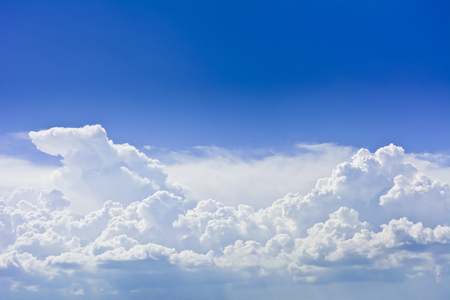 Group dense clouds before the storm against a blue sky. Clouds lit by the rays of the sun.の写真素材