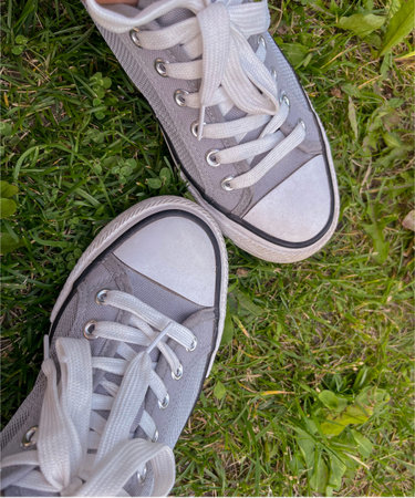 summer gray sneakers on the green grass in summer