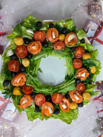 salad of red fish and arugula greens, tomatoes and olives on a large round platterの写真素材
