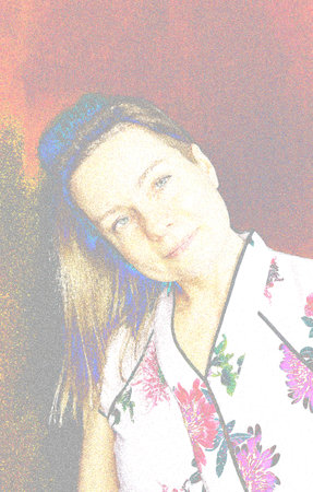 portrait of a 50-year-old woman with long blonde hair on a red background