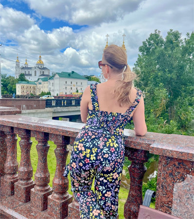a woman poses in front of the city of Vitebsk, Belarus
