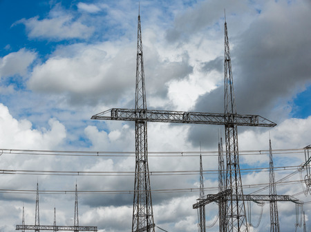 Electric power transmission lines. High voltage switchgear and equipment in front of power plant.の写真素材