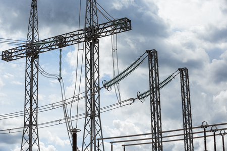 Electric power transmission lines. High voltage switchgear and equipment in front of power plant.の写真素材
