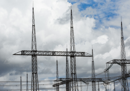 Electric power transmission lines. High voltage switchgear and equipment in front of power plant.の写真素材