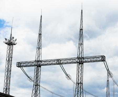 Electric power transmission lines. High voltage switchgear and equipment in front of power plant.の写真素材